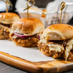 three sliders on a cutting board