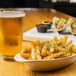 a plate of fries and a glass of beer
