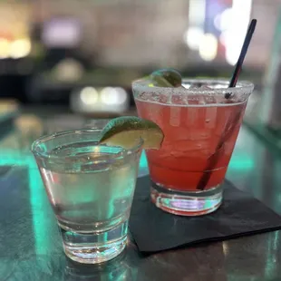 two cocktails on a bar