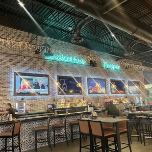 a brick wall with neon signs