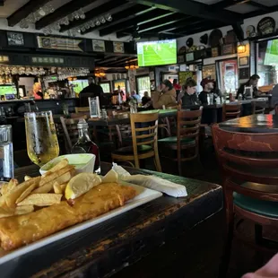 Lunch size! Fish/chips/mushy peas. Pub interior view.