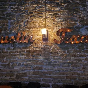 a brick wall with a lit up sign