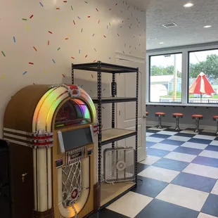a juke box in the middle of a checkered floor