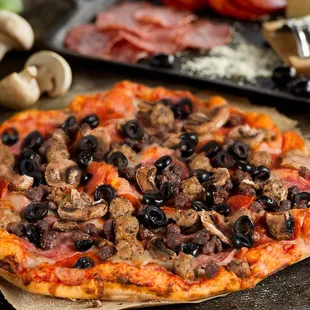 a pizza with mushrooms and olives
