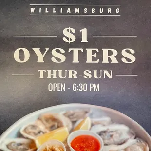 oysters on a plate with lemon wedges