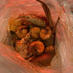 Crab leg cluster, shrimp, corn, sausage, and potato