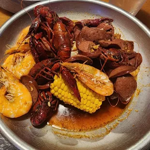Create your own w/ 1/2 whole shrimp 1/2 crawfish add sausage and Cajun sauce medium (it's spicy)