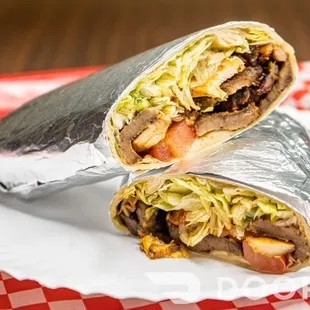 a burrito cut in half on a plate