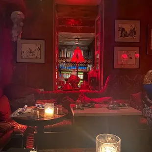 a woman sitting at a table in a dimly lit room