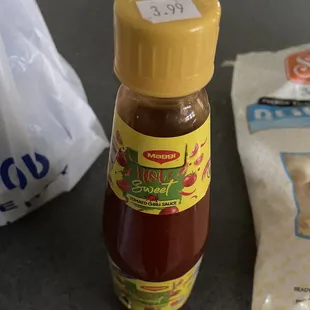 a bottle of sauce and a bag of chips