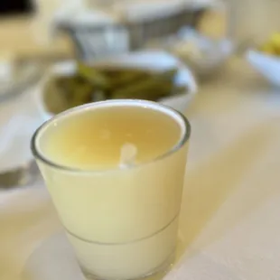 a glass of milk and a bowl of pickles