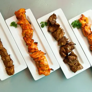 Koobideh skewer, chicken thigh skewer, beef barg skewer, and chicken breast skewer (from left to right.)