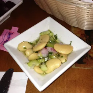 Lima beans with red onion and cucumber in a garlic oil dressing.