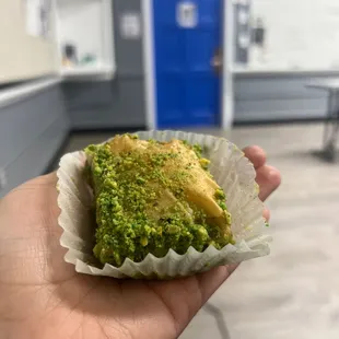 a hand holding a piece of food