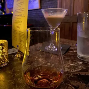 a glass of whiskey on a table