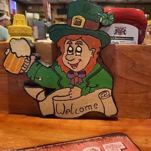 a wooden sign with a leprezi on it