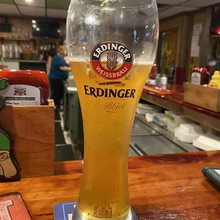 a glass of beer on a bar