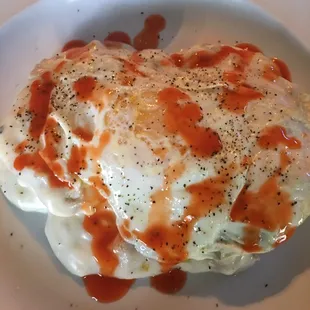 Biscuits and gravy with an over easy egg. Plus lots of hot sauce.