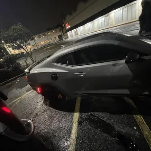 a silver sports car in a parking lot