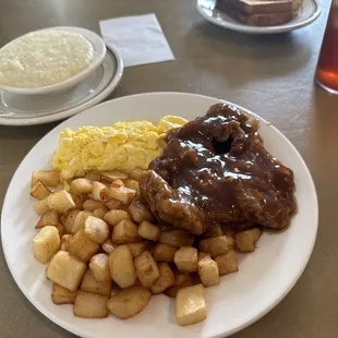 Tenderloin with eggs potatoes and grits