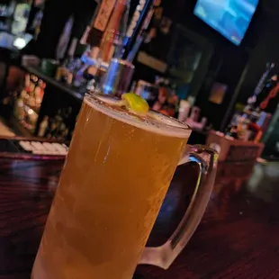 a glass of beer on a bar