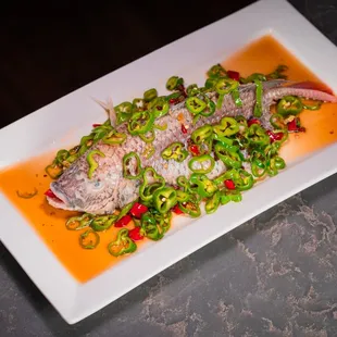 Steamed whole Tilapia fish with Peppercorn and fresh green cayenne pepper.