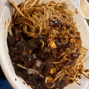 a plate of noodles and meat