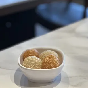  a bowl of balls of food on a table