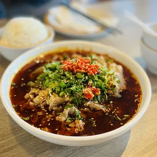 a bowl of soup with meat and vegetables