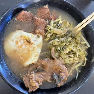 Braised pork chop noodle soup with extra pickled cabbage and extra fried egg