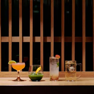 three cocktails on a wooden table