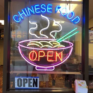 a neon sign of a bowl of noodles