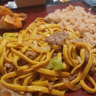 a plate of noodles with meat and vegetables