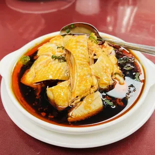 a bowl of soup with fish and vegetables