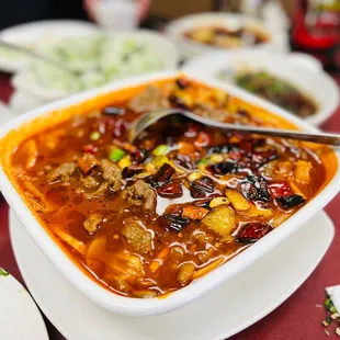 a bowl of soup with a spoon in it