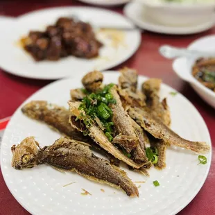 a plate of fried fish on a table