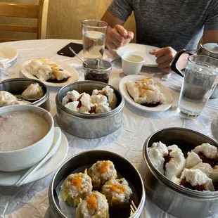 a man sitting at a table full of dim dim dim dim dim dim dim dim dim dim dim dim dim dim dim dim
