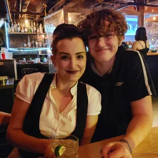 a man and a woman sitting at a bar