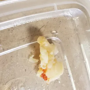 a peeled banana in a plastic container