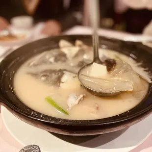 a bowl of soup with a spoon in it
