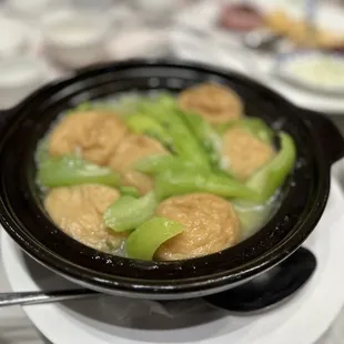 a bowl of soup with dumplings and celery