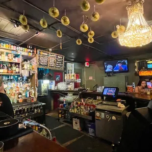 a view of a bar with people sitting at the bar