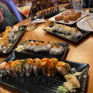 a woman taking a picture of sushi