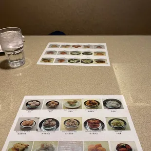 a menu and a glass of water