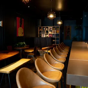 a row of chairs at a bar