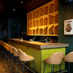 a row of chairs at a bar