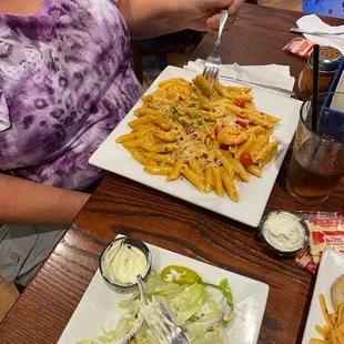 a plate of pasta and salad