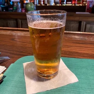 a pint of beer on a napkin