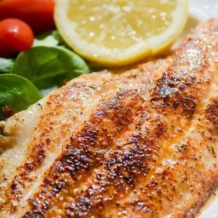 a plate of fish and a salad