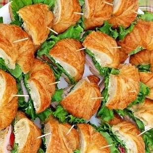a plate of croissant sandwiches